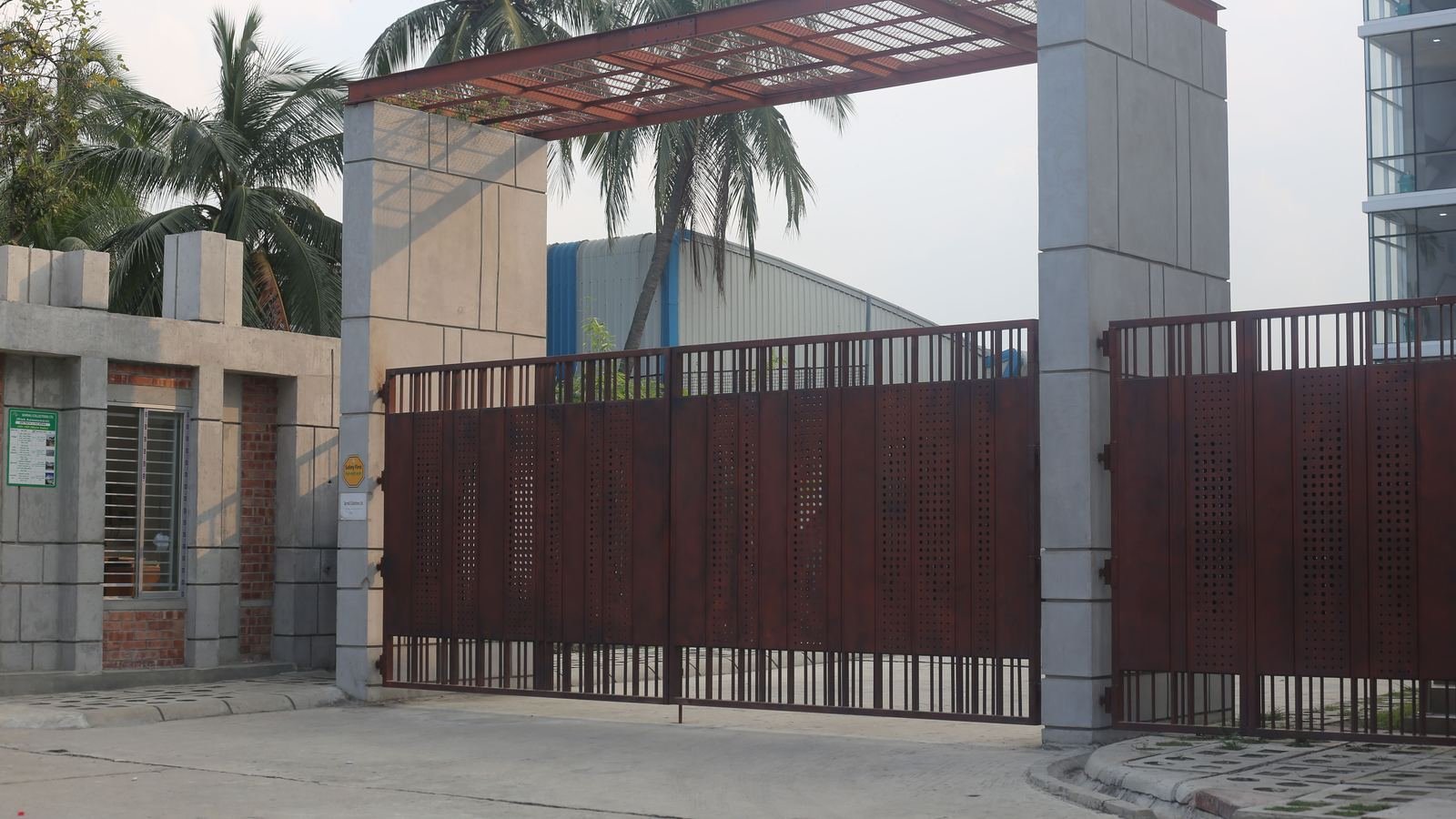 Completed MS main gate with grill infill at a compound entrance in Karaikudi